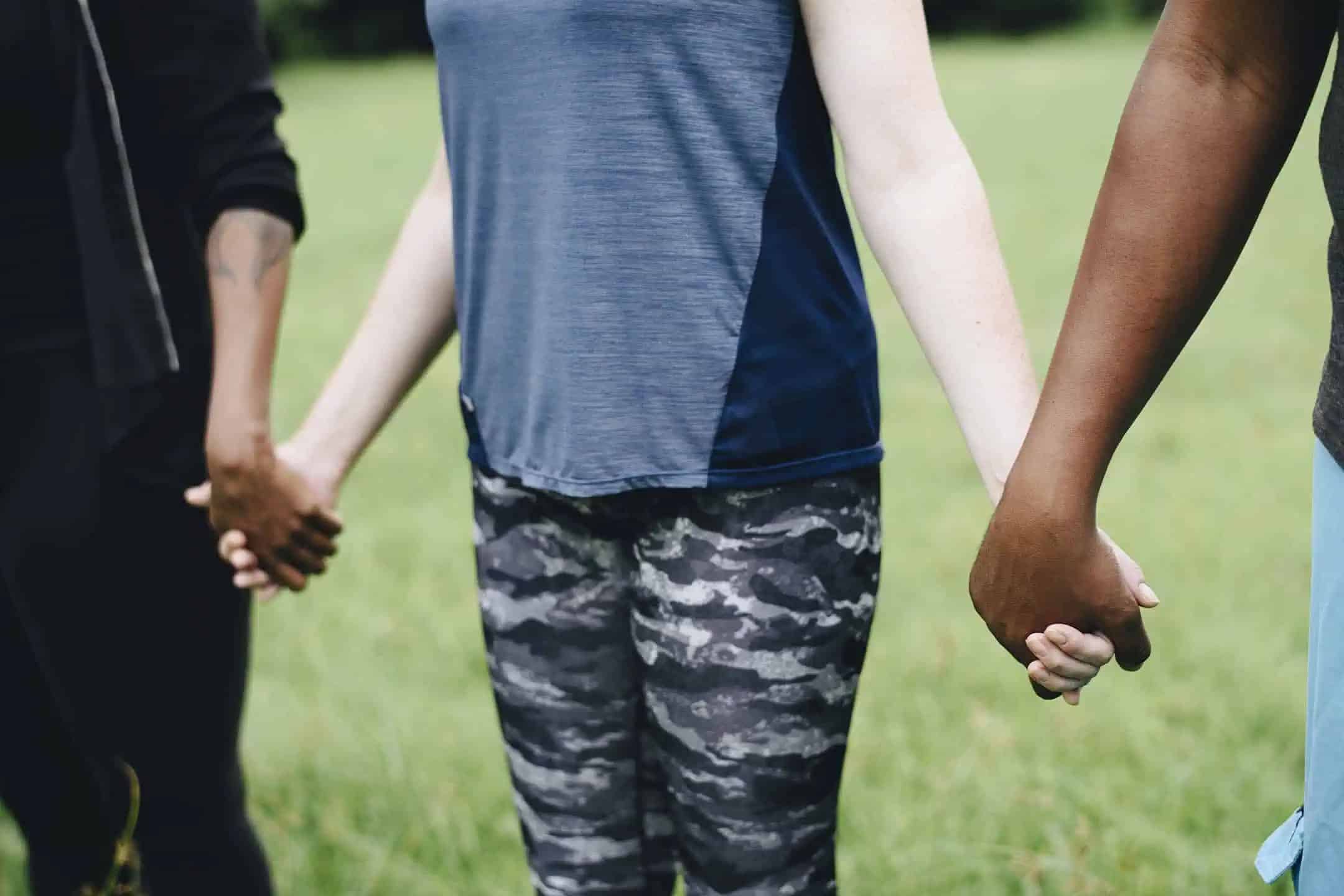 Diverse people holding hands in the park
