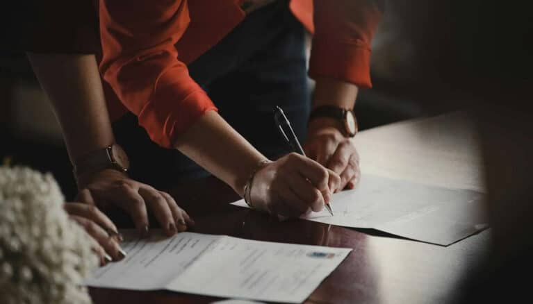 People signing legal paperwork