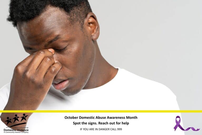 Man holding bridge of nose in sadness.