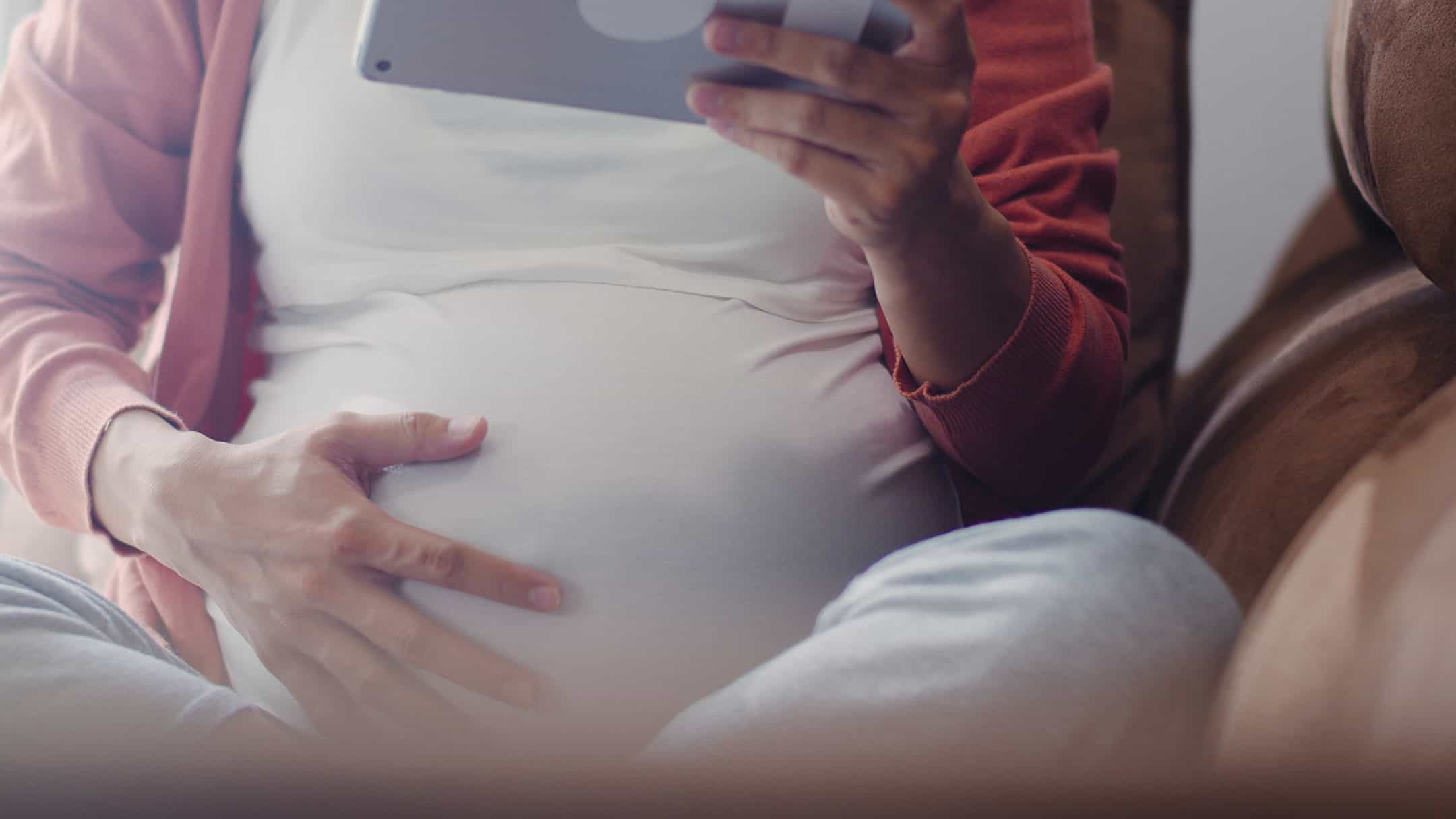 When pregnancy isn't safe 1 Young Asian Pregnant woman using tablet